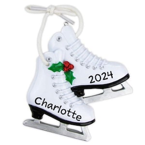 May include: White ice skate Christmas ornament with a holly sprig and the year 2024 on one skate and the name Charlotte on the other.