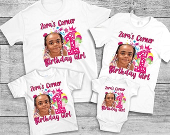 May include: A set of four white t-shirts with a pink and white birthday design. The design features a girl's face, a pink number one, and the text "Zora's Corner Birthday Girl".