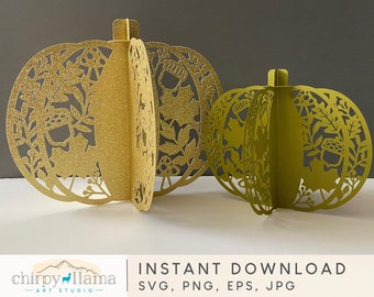 May include: Two decorative paper pumpkins with intricate cut-out designs. The larger pumpkin is gold with a glitter finish and the smaller pumpkin is green. Both pumpkins have a floral and leaf pattern.