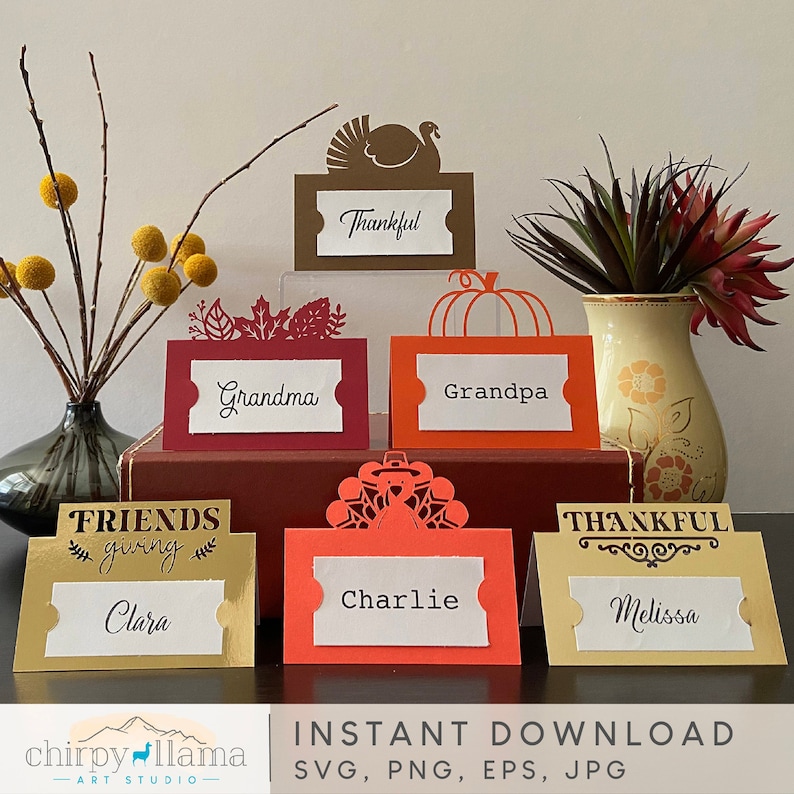 May include: Set of ten Thanksgiving place cards with various designs. The cards are decorated with turkeys, pumpkins, and leaves. The names "Clara", "Charlie", "Melissa", "Grandma", "Grandpa", and "Thankful" are written on the cards.