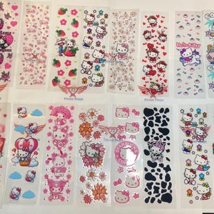 May include: A sheet of 16 colorful sticker designs featuring Hello Kitty and other Sanrio characters. The stickers are printed on clear plastic and are perfect for decorating laptops, water bottles, and other items.