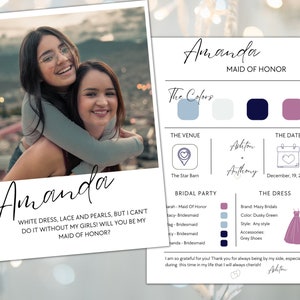 May include: A wedding invitation card with a photo of two women smiling. The card is decorated with a floral pattern and has the text "Amanda Maid of Honor" and "White dress, lace and pearls, but I can't do it without my girls! Will you be my Maid of Honor?"