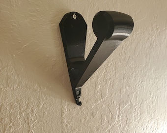 Wall mounted helmet holder