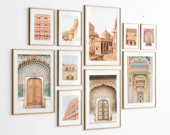 May include: A collection of nine framed prints featuring various architectural details of a palace in India. The prints are arranged in a grid pattern on a white wall. The prints feature intricate details, such as arches, doors, and windows, and are all in shades of pink, blue, and gold.