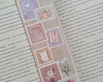 May include: A close-up of an open book with pink and white decorative stamps on the pages. The text on the page reads "That is so wild," says Rosemary. "Does she talk to you, or skulk around?"