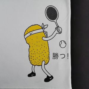 May include: White athletic shirt with a cartoon yellow character playing tennis. The character has a white headband with a Nike logo and black shoes. A tennis ball and racket are also shown. Japanese text "Katsu!" is printed on the shirt.