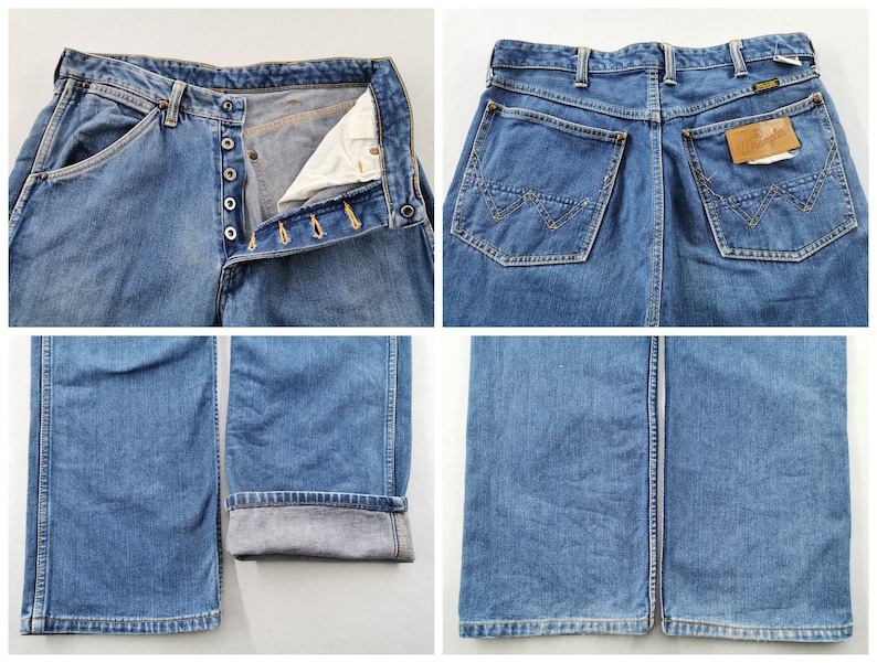May include: Blue denim jeans with button fly closure and classic five-pocket design. The jeans feature a straight leg cut and a Wrangler brand label on the back pocket. The jeans are a medium wash and show signs of wear.
