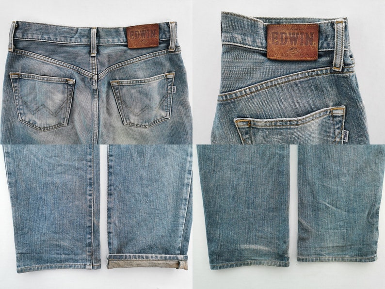 May include: Light blue denim jeans with a faded wash. The back features two pockets and a brown leather patch with the brand name "EDWIN". The jeans have a classic five-pocket design and a straight leg.