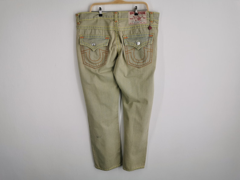 May include: A set of three ceramic mugs with a speckled, matte finish. The mugs are in shades of cream, light gray, and dark gray. Each mug has a simple, minimalist design, perfect for coffee or tea.