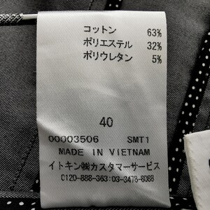 May include: Close-up of a white clothing tag with Japanese text and percentages for cotton, polyester, and polyurethane. The tag also includes the size 40, the text "MADE IN VIETNAM", and a customer service phone number.