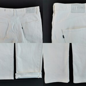 May include: White denim jeans with a classic five-pocket design. The jeans have a straight leg cut and a leather patch with the brand name. The jeans are shown from multiple angles, including the back pockets and the folded hem.