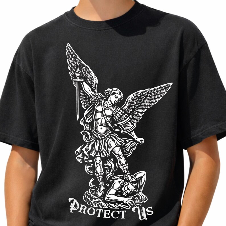 May include: Black t-shirt featuring a white graphic of an angel with a sword, standing over a figure. The text "PROTECT US" is below the graphic. The shirt is made of a soft material.