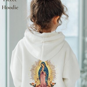 May include: White toddler fleece hoodie with a religious image on the back. The image features a woman in a blue and pink robe, surrounded by a golden halo and angels. The text "Toddler Pullover Fleece Hoodie" is printed on the left side.