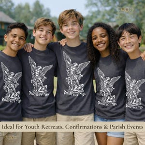 May include: Five smiling people wearing dark gray t-shirts with a white graphic of an angel slaying a demon, with the text "PROTECT US" below. The image is taken outdoors.