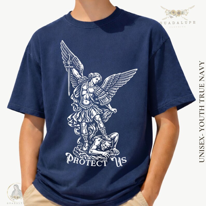 May include: Navy blue t-shirt featuring a white graphic of an angel with a sword, standing over a figure. The text "PROTECT US" is below the graphic. The shirt is labeled "UNISEX - YOUTH TRUE NAVY".