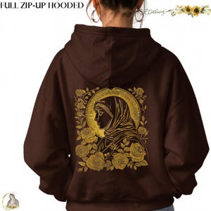 May include: A brown full zip-up hooded sweatshirt. The back features a gold illustration of a woman's profile surrounded by roses and text. The text "FULL ZIP-UP HOODED" is at the top.