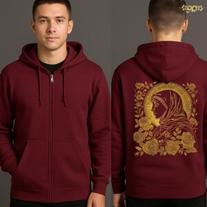 May include: A burgundy zip-up hoodie. The back features a gold illustration of a woman's profile surrounded by roses and text. The front has a full-length zipper and a kangaroo pocket.