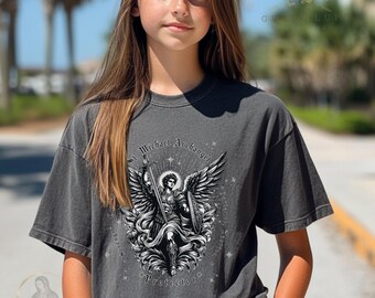 May include: Dark gray t-shirt featuring a detailed black and white illustration of St. Michael the Archangel, holding a sword and shield, with the text "St. Michael Archangel Protector". The shirt has a vintage, washed look.