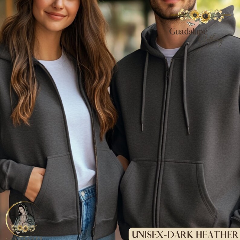 May include: Two people wearing dark heather gray zip-up hoodies. The hoodies have front pockets and drawstrings on the hood. The text "UNISEX-DARK HEATHER" is at the bottom of the image.