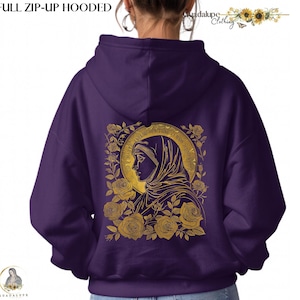 May include: A purple full zip-up hooded sweatshirt. The back features a gold illustration of a religious figure surrounded by roses. The text "FULL ZIP-UP HOODED" is at the top. The brand name "Guadalupe Clothing" is also visible.