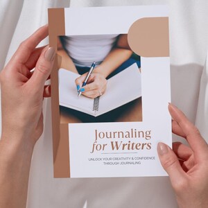 May include: A book cover with the title "Journaling for Writers" in a serif font. The cover has a white background with a brown border and a photo of a person writing in a notebook. The text below the title reads "UNLOCK YOUR CREATIVITY & CONFIDENCE THROUGH JOURNALING."