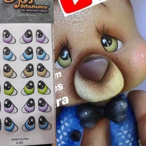 May include: A sheet of 24 self-adhesive googly eyes in various colors and patterns. The eyes are triangle-shaped and have a black pupil. The sheet is labeled "Ojos Autoadhesivos de Mariela Lopez".
