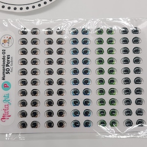 May include: A sheet of 50 pairs of humanized doll eyes in various colours, including brown, blue, green, and grey. The eyes are 6mm x 8mm and are packaged in a clear plastic bag.