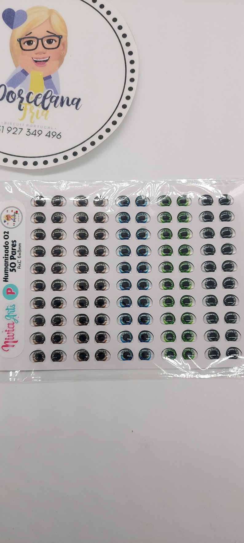 May include: A sheet of 50 pairs of humanized doll eyes in various colours, including brown, blue, green, and grey. The eyes are 6mm x 8mm and are packaged in a clear plastic bag.