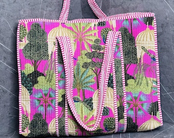 May include: A pink tote bag with a white and pink striped trim. The bag features a colorful floral and bird print.