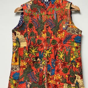 May include: A sleeveless, quilted vest with a vibrant red background and a colorful botanical print. The pattern includes palm trees, flowers, and figures. The vest has a mandarin collar, two pockets, and a button-up front.