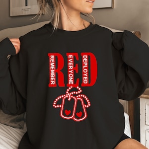 May include: Black sweatshirt with a red graphic that says "RED DEPLOYED EVERYONE REMEMBER" with two red dog tags with hearts hanging from the word "RED".