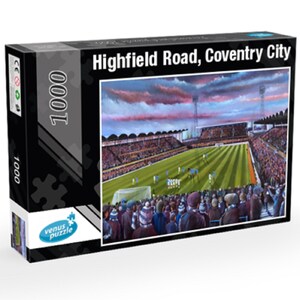 May include: A 1000 piece jigsaw puzzle featuring a painting of Highfield Road, Coventry City. The image shows a football stadium with a green field and a crowd of people in the stands. The sky is a vibrant pink and orange.