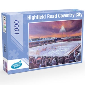May include: A 1000 piece jigsaw puzzle featuring a snowy football stadium with a crowd of fans in the stands. The stadium is lit up by floodlights and the sky is a vibrant orange and purple. The box features the text "Highfield Road Coventry City".