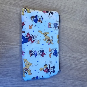 May include: White zippered pouch with a repeating pattern of Mickey Mouse, Minnie Mouse, Donald Duck, and Goofy characters on a white background.