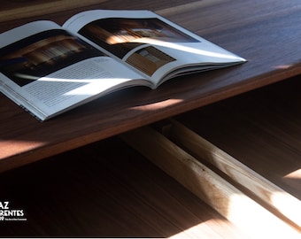 May include: A close-up of a wooden drawer with two open drawers. The drawers are made of light wood and have a natural finish. A magazine is lying on top of the drawer, partially covering the top drawer.