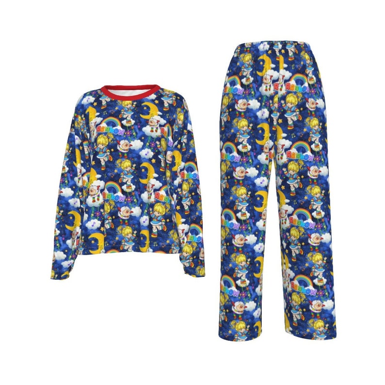 May include: Blue pajamas with a long-sleeved top and pants. The pajamas feature a repeating pattern of a girl with a rainbow and stars on a dark blue background.