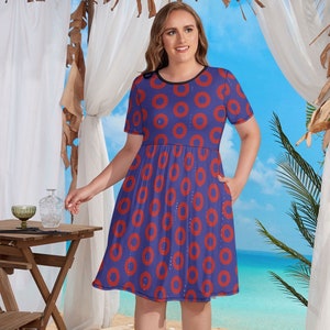 May include: A blue and red short-sleeved dress with a donut pattern. The dress has a round neckline and a fitted bodice. The skirt is full and flows out from the waist.