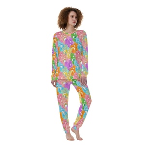 May include: A women's pajama set with a colorful Care Bears print. The top is long-sleeved and the pants are joggers.