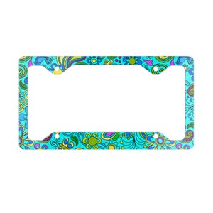 May include: A license plate frame with a vibrant, colorful floral pattern. The frame features a turquoise background with a repeating design of flowers, leaves, and swirls in shades of blue, yellow, and purple.