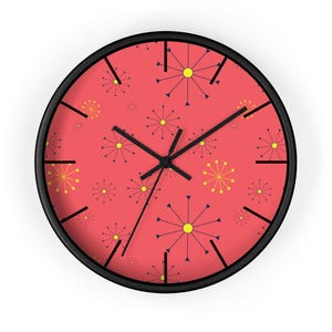 May include: A red wall clock with a black frame and a pattern of yellow and blue stars. The clock hands are black.