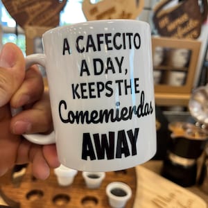 Cafecito Mug: "A Cafecito A Day Keeps The Comemierdas Away" 12 oz Mug