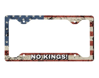 No Kings! Metal license plate frame with tattered American flag in the background