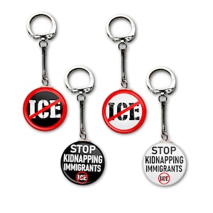 May include: Four keychains with round pendants. Two pendants have a red circle with a white "ICE" crossed out. The other two pendants say "STOP KIDNAPPING IMMIGRANTS" with "ICE" at the bottom. All have silver key rings.