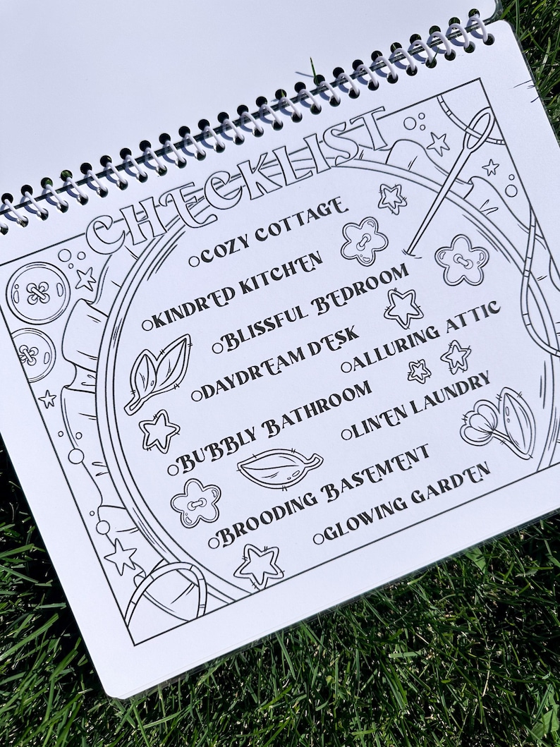 May include: A spiral-bound notebook with a black and white checklist design. The word "CHECKLIST" is at the top, with themed room names like "Cozy Cottage" and "Glowing Garden" listed below. Decorative elements include stars, flowers, and sewing tools.