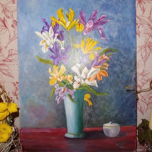 May include: A painting of a bouquet of yellow, purple, and white irises in a blue vase on a red table. The painting is signed "M. Swift 1962".