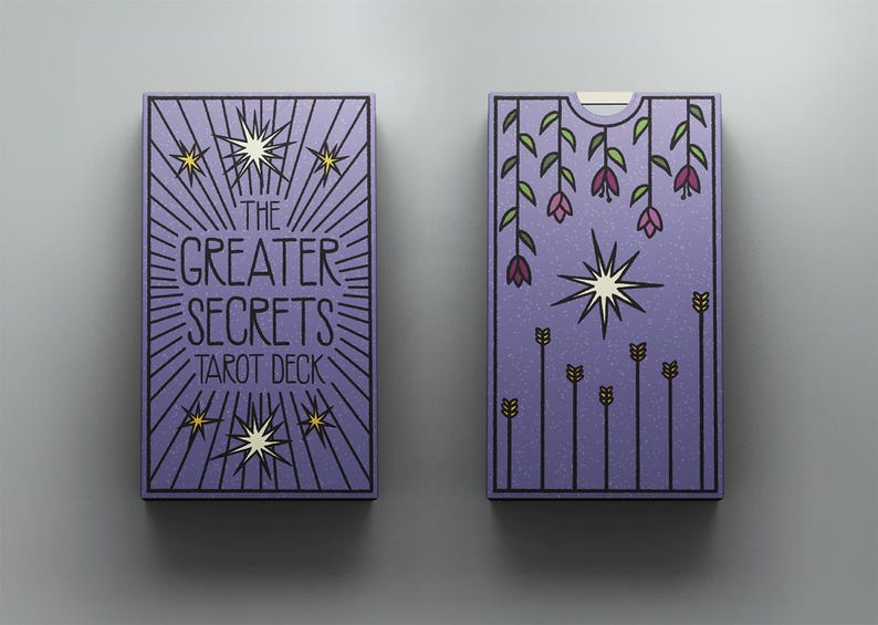 May include: A purple tarot deck box featuring the text The Greater Secrets Tarot Deck in black lettering, surrounded by radiating lines and star icons. The reverse side displays hanging purple flowers, a central star, and vertical stalks.