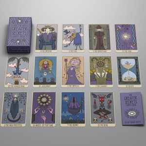 May include: The Greater Secrets Tarot Deck featuring a purple box and a matching guidebook. Fourteen illustrated tarot cards are displayed, including The Emperor, The Fool, The Hierophant, The Star, The Hanged Man, Judgement, The Empress, The Chariot, Death, The High Priestess, Wheel of Fortune, The Hermit, and The Devil.