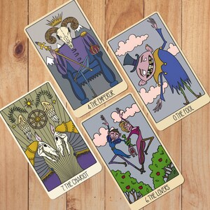 May include: Four tarot cards featuring stylized illustrations: The Emperor with a ram skull, The Fool in a top hat, The Chariot with two skeletal creatures, and The Lovers with two figures. Each card displays its name and number in black text.