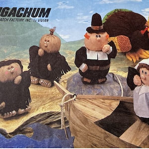 May include: A set of four plush toys, including a pilgrim, a pumpkin, a turkey, and a pilgrim woman. The toys are all wearing traditional pilgrim clothing and are sitting in a wooden boat. The toys are from the Patch Factory, Inc. and are designed by Vivian.