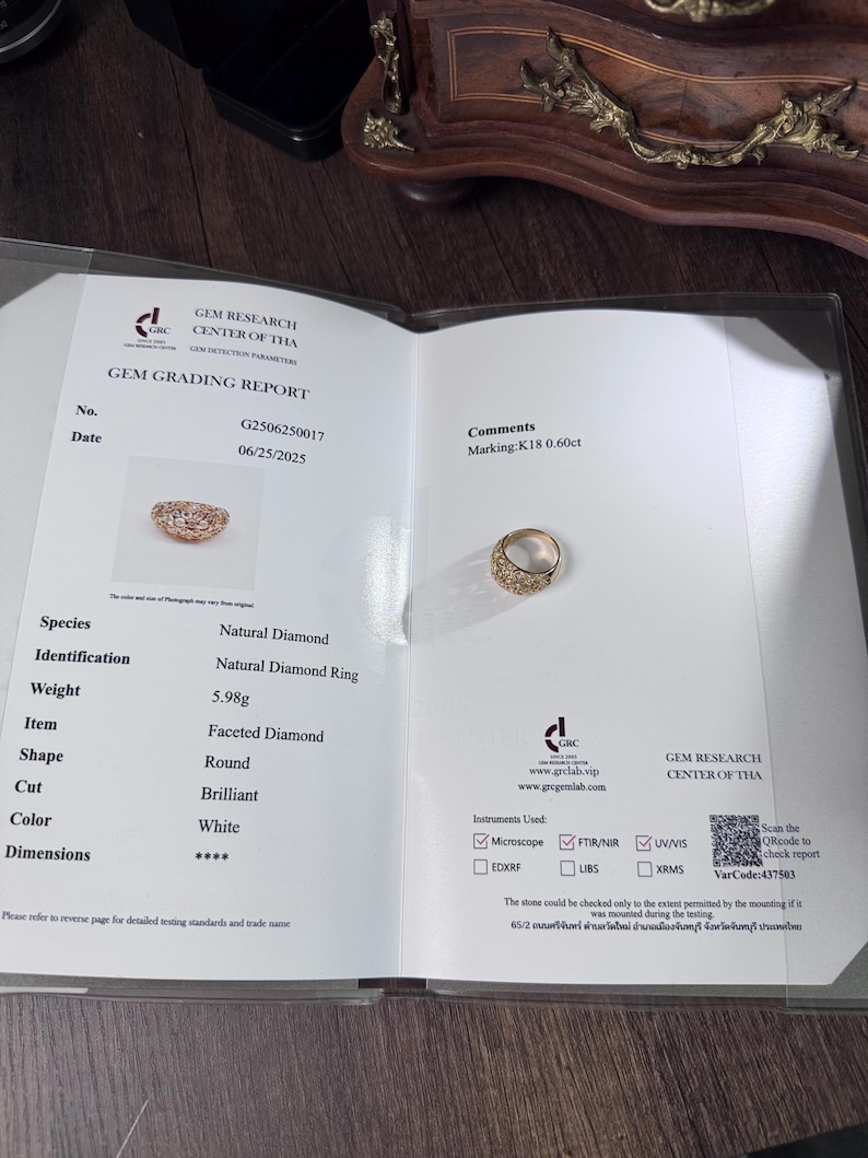 May include: A Gem Grading Report displays a natural diamond ring. The ring is round, faceted, and brilliant cut, with a white color. The report indicates a weight of 5.98 grams and a marking of K18 0.60ct.